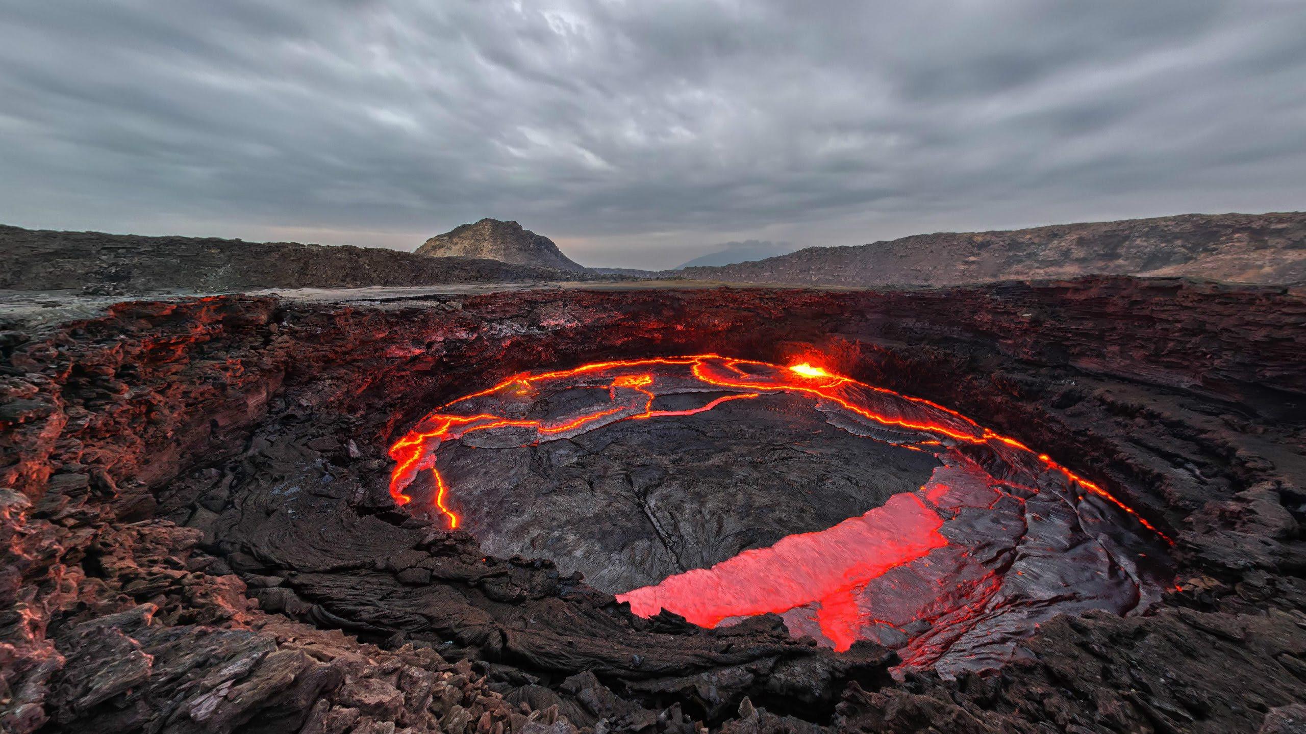The active lava lake in the crater of Erta Ale volcano in the Danakil Depression, glowing against dark volcanic rock