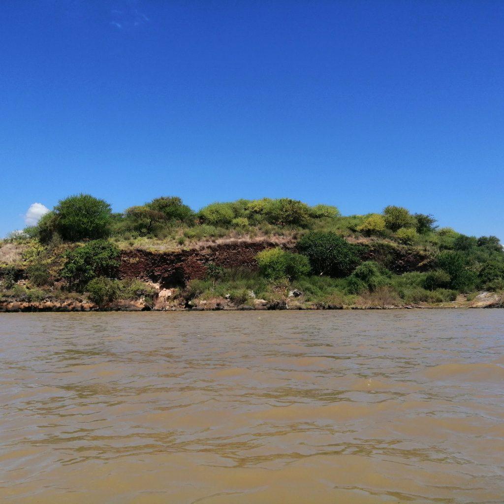 A green island rising from the brown water of Lake Chamo near Arba Minch