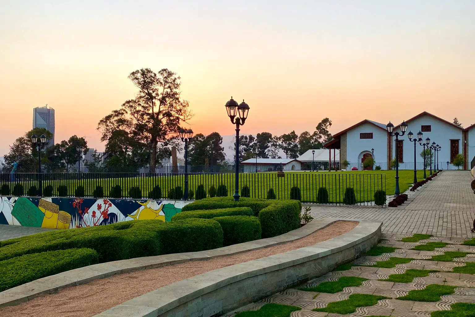 Gardens and palace buildings of Unity Park in Addis Ababa at sunset